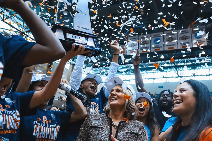 UT San Antonio Basketball team celebrating with their championship trophy