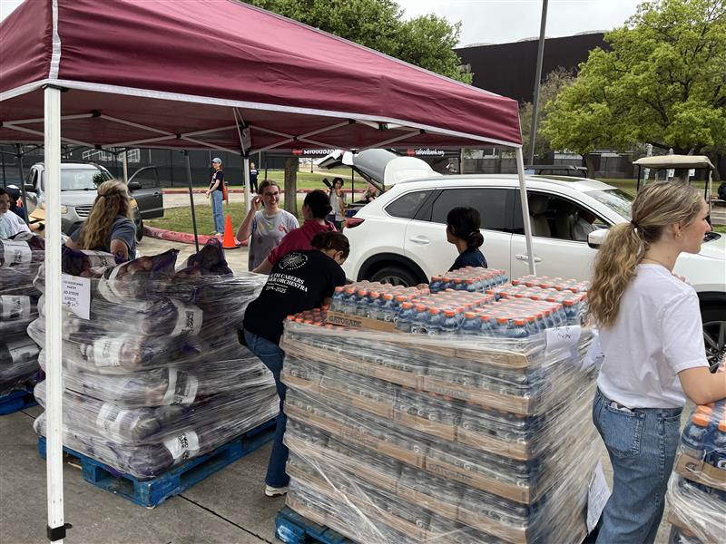 Mobile distribution meal pallets and car pick up lane with volunteers