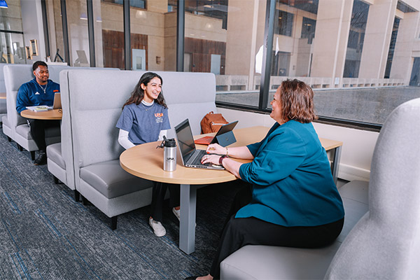 Student and staff member interacting the HCAP student success center