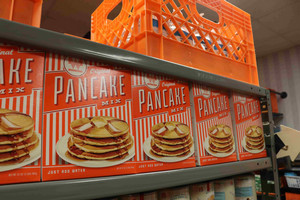 Boxes of pancake mix on a shelf.