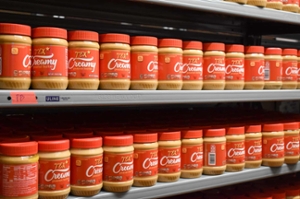 Shelves with jars of peanut butter.