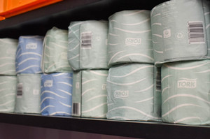 Shelf with rolls of toilet paper.
