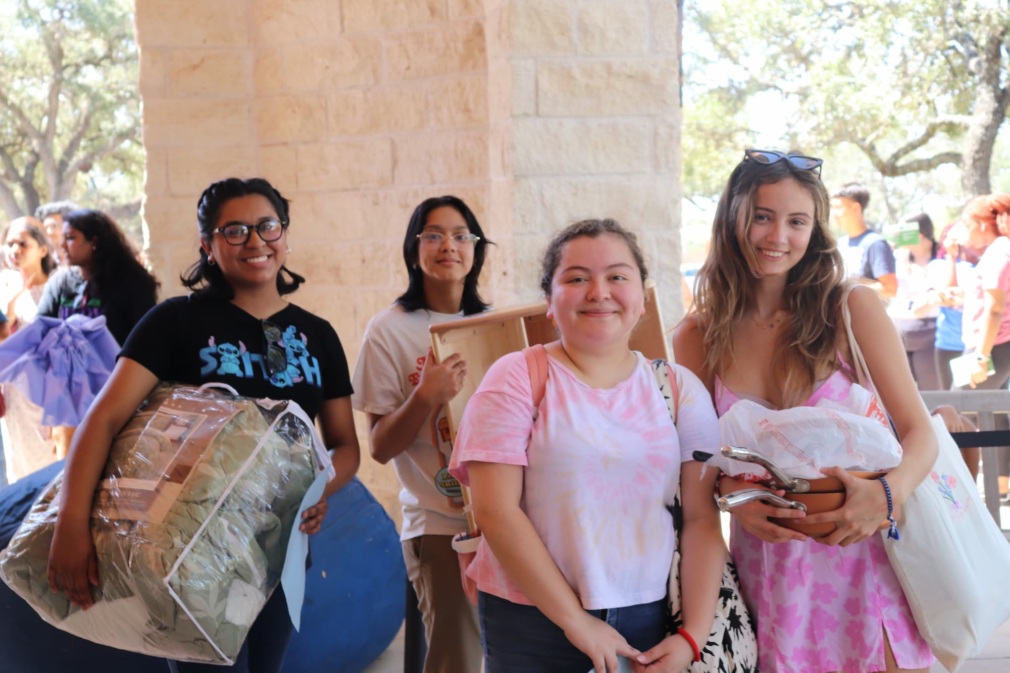 group of students holding household items